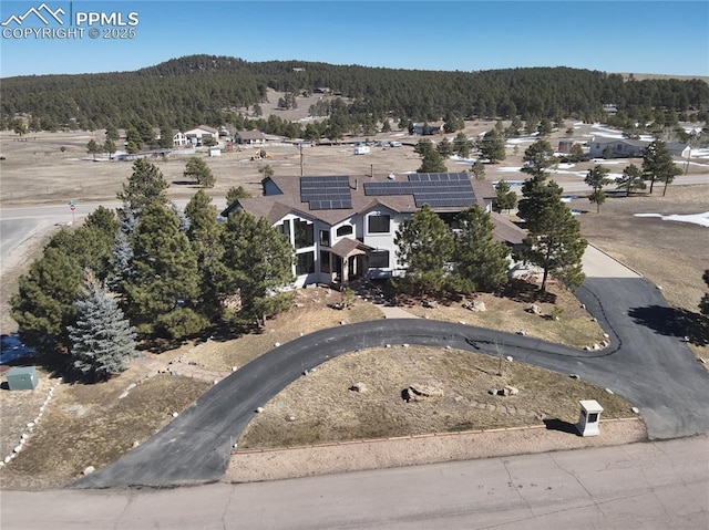 birds eye view of property with a wooded view