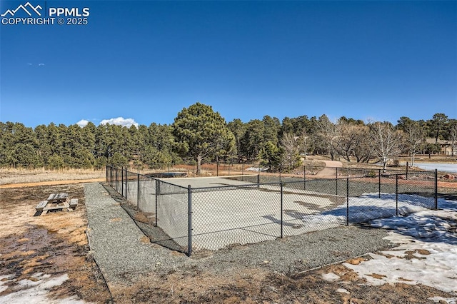 view of sport court featuring fence