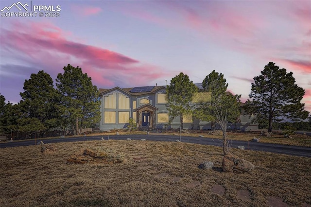 view of front of home featuring solar panels