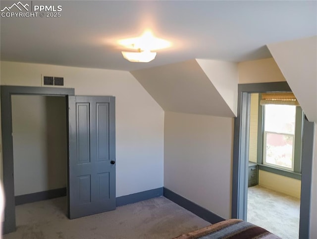 bonus room featuring carpet floors, lofted ceiling, visible vents, and baseboards