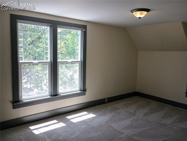 bonus room featuring carpet floors, vaulted ceiling, and baseboards