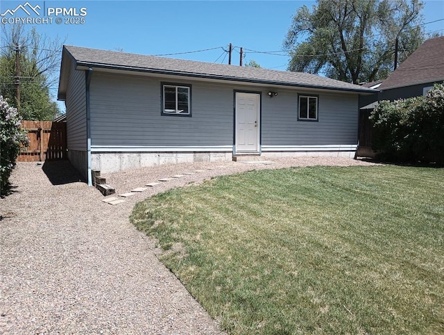 view of front of house with fence and a front lawn