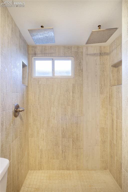 full bath featuring a tile shower and toilet