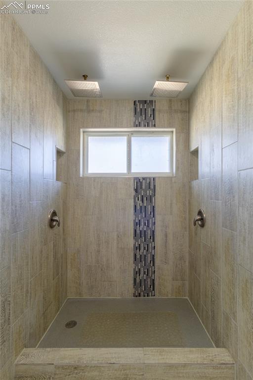 bathroom with a tile shower