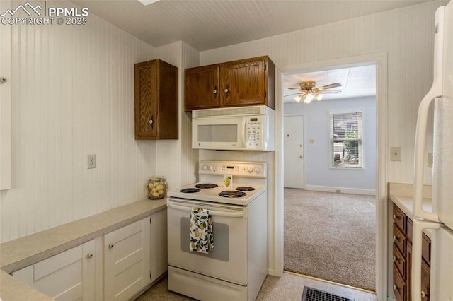 kitchen featuring carpet floors, light countertops, visible vents, a ceiling fan, and white appliances