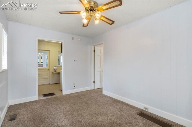 unfurnished bedroom with carpet floors, visible vents, and baseboards