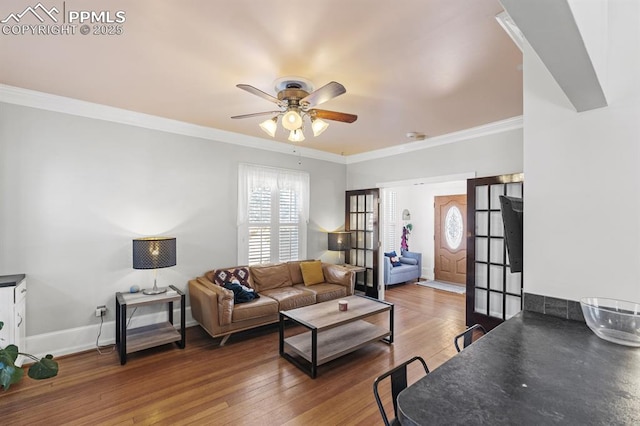 living room with crown molding, baseboards, ceiling fan, and hardwood / wood-style floors