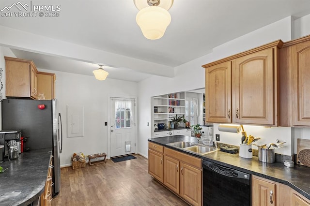 kitchen featuring black dishwasher, dark countertops, a sink, light wood-type flooring, and beamed ceiling