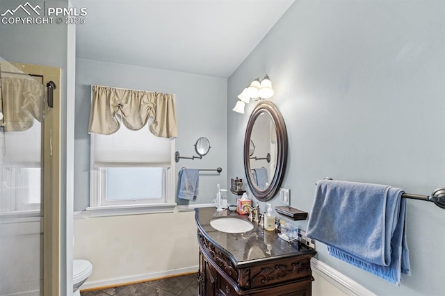 bathroom with toilet, vanity, baseboards, tile patterned floors, and an enclosed shower