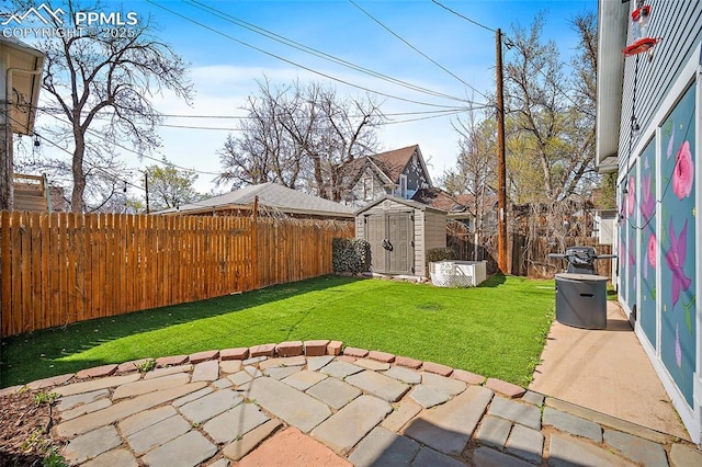 view of yard featuring an outdoor structure, a storage unit, a fenced backyard, and a patio