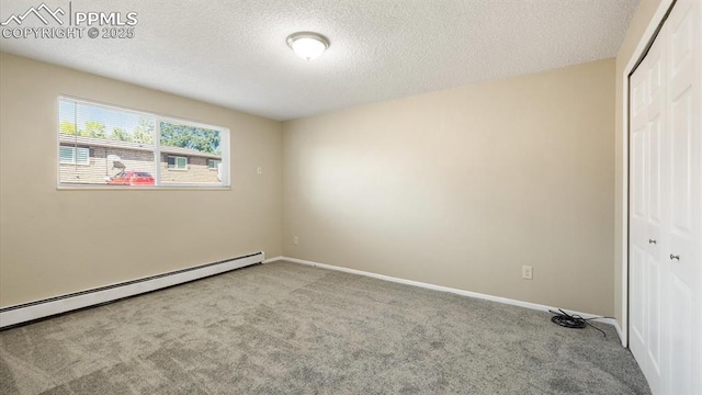 unfurnished bedroom with baseboards, carpet flooring, a closet, a textured ceiling, and a baseboard radiator