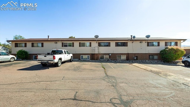 view of building exterior with uncovered parking