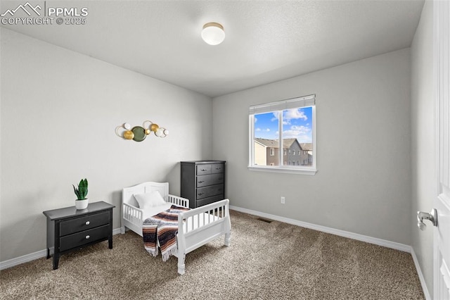 carpeted bedroom with visible vents and baseboards