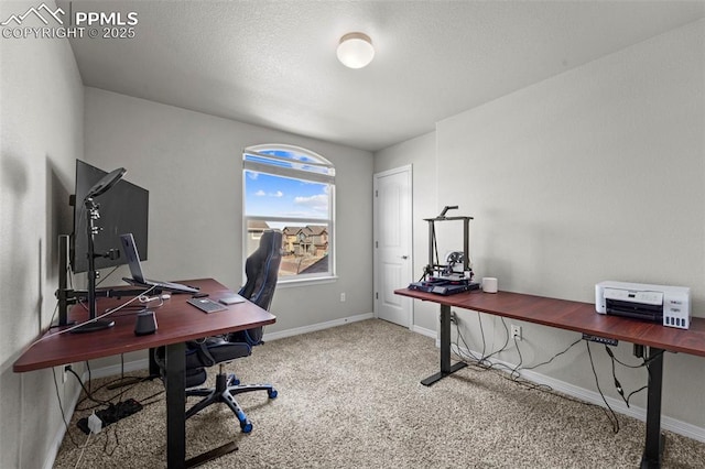 home office featuring a textured ceiling, baseboards, and carpet flooring