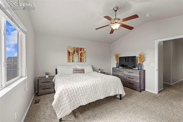 bedroom featuring ceiling fan, light colored carpet, visible vents, baseboards, and vaulted ceiling