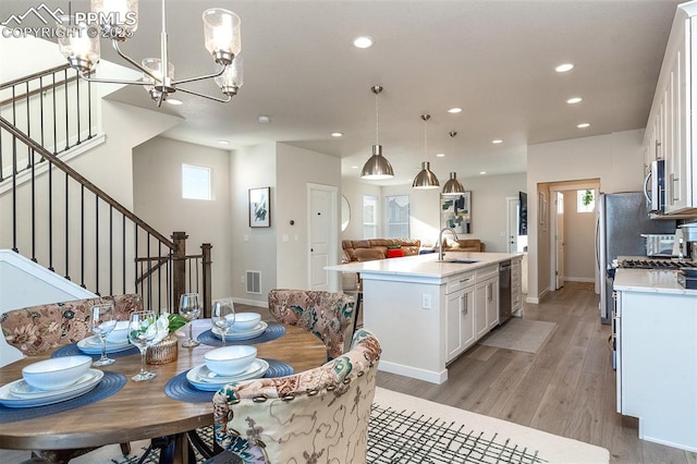 dining area with recessed lighting, visible vents, a healthy amount of sunlight, stairway, and light wood finished floors