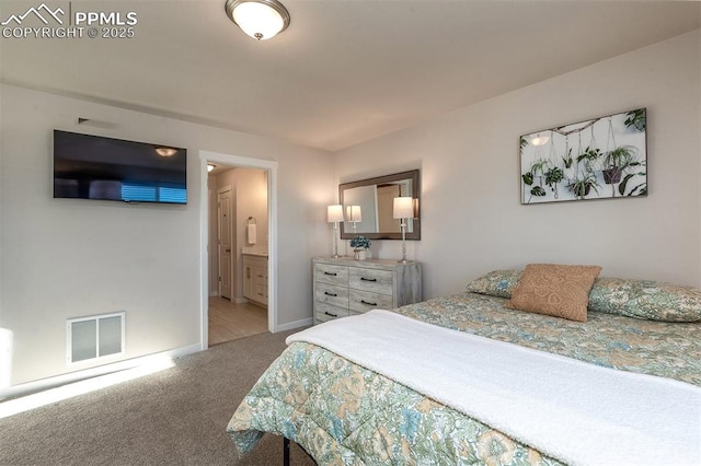 bedroom with carpet floors, ensuite bath, visible vents, and baseboards