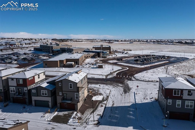 snowy aerial view with a residential view