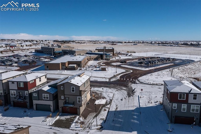 snowy aerial view with a residential view