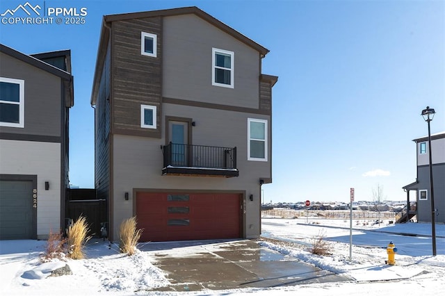 view of front of house featuring a balcony and a garage