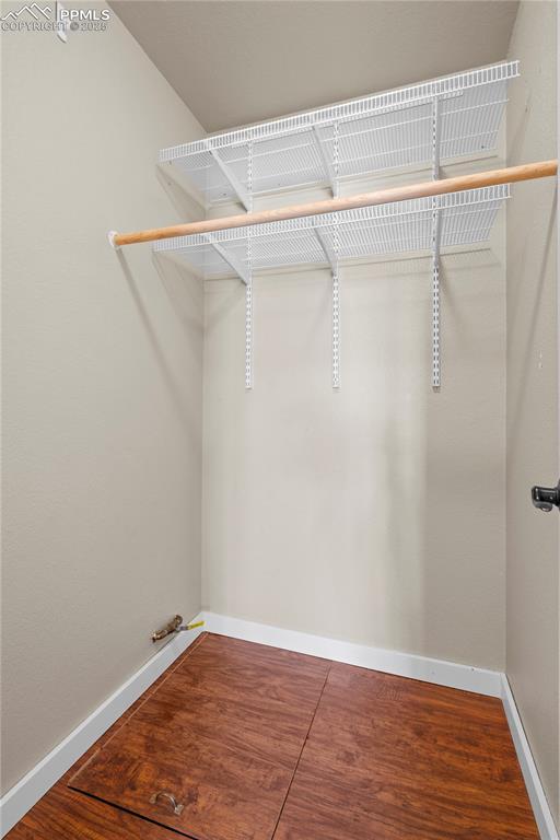 walk in closet featuring wood finished floors