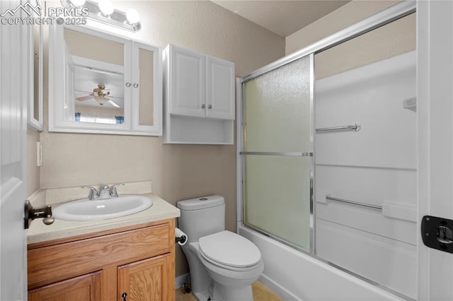 full bath with toilet, bath / shower combo with glass door, and vanity