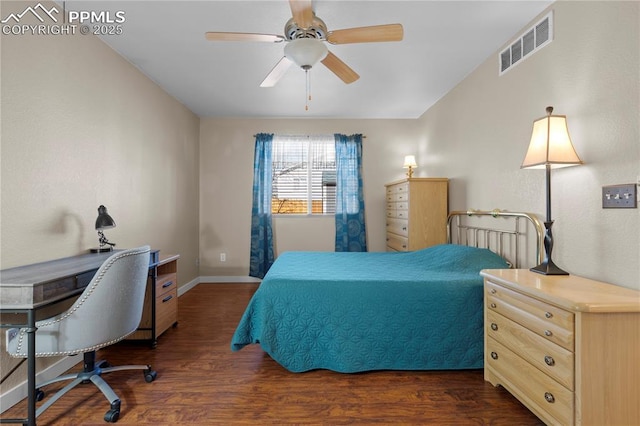 bedroom featuring dark wood-style floors, a ceiling fan, visible vents, and baseboards