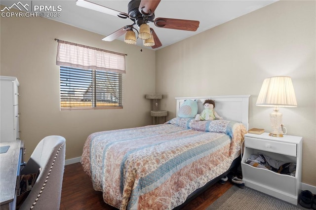 bedroom with a ceiling fan, baseboards, and wood finished floors