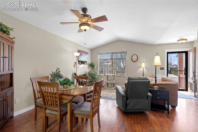 dining room with lofted ceiling, ceiling fan, wood finished floors, and baseboards