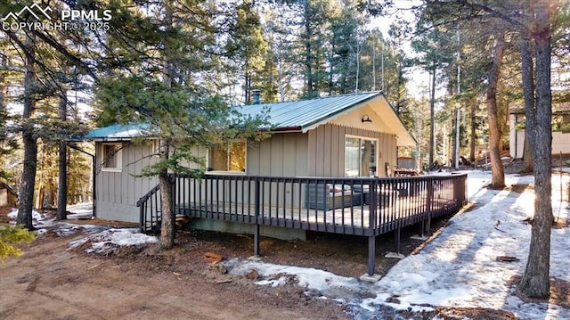 back of property with a deck and metal roof