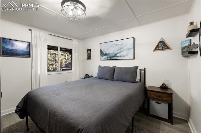 bedroom featuring baseboards and wood finished floors