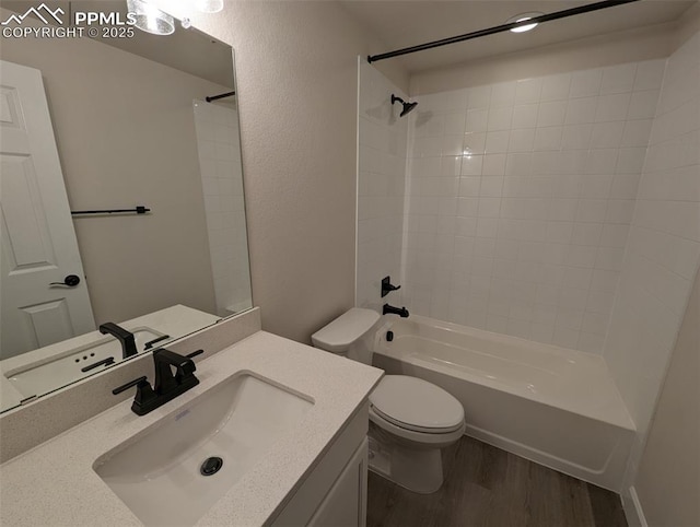 full bathroom with vanity, bathtub / shower combination, wood finished floors, and toilet