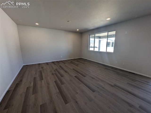 unfurnished room featuring visible vents, baseboards, dark wood-type flooring, and recessed lighting