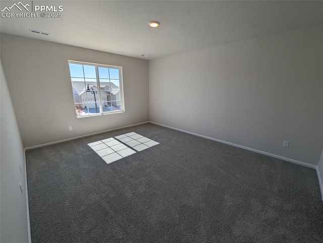 empty room featuring carpet floors, visible vents, and baseboards