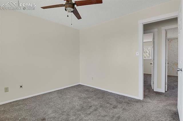 carpeted spare room with a textured ceiling, a ceiling fan, and baseboards