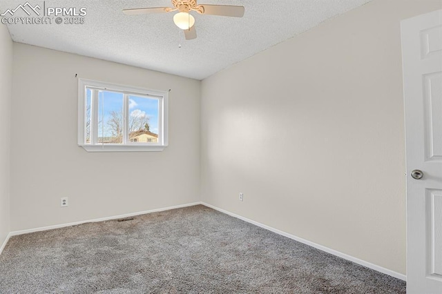 empty room featuring a ceiling fan, carpet, a textured ceiling, and baseboards