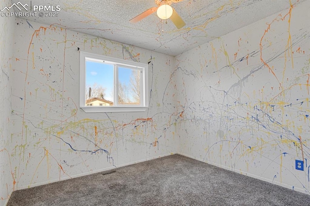 carpeted spare room with a ceiling fan, visible vents, and a textured ceiling