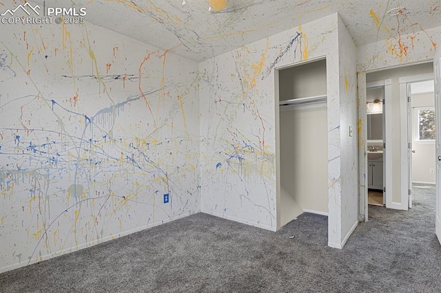 unfurnished bedroom featuring carpet floors, a sink, and a closet