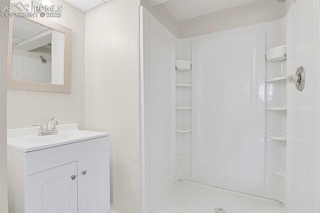 bathroom with a shower and vanity