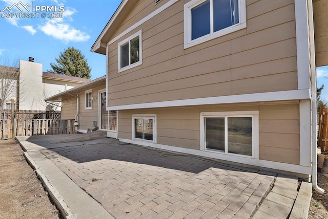 back of house with a patio and fence