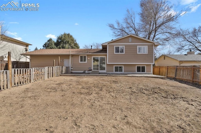 rear view of property with a patio area and a fenced backyard