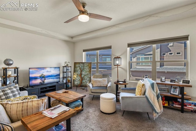 carpeted living room featuring a ceiling fan