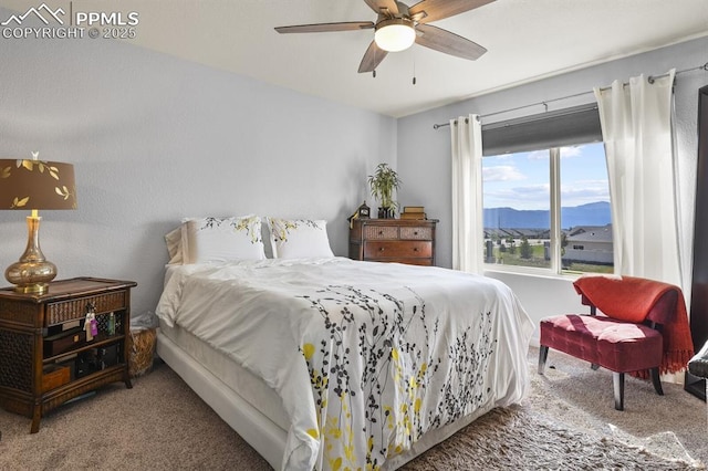 bedroom with carpet, a mountain view, and a ceiling fan