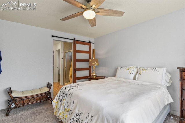 bedroom featuring carpet floors, a barn door, and a ceiling fan