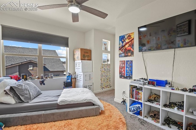 carpeted bedroom featuring ceiling fan and baseboards