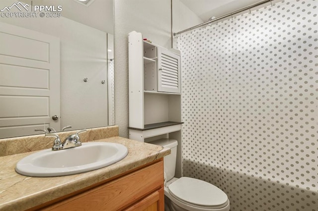 bathroom with a shower, vanity, and toilet