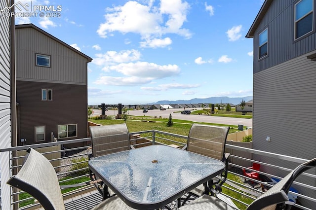 balcony with outdoor dining space and a mountain view