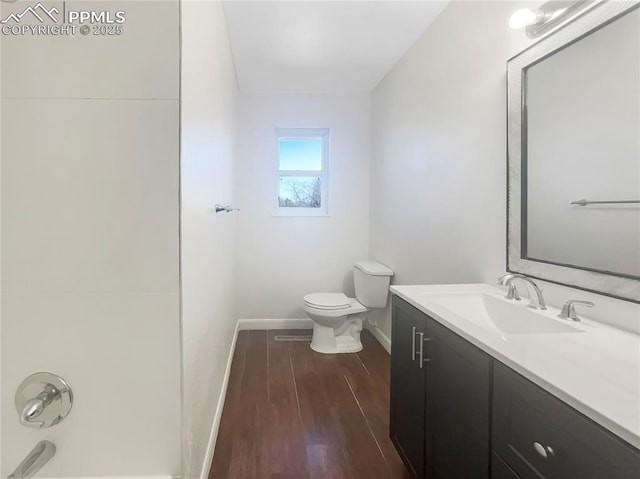 full bathroom with toilet, wood finished floors, vanity, and baseboards