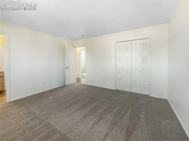 unfurnished bedroom with carpet, a closet, and a textured ceiling