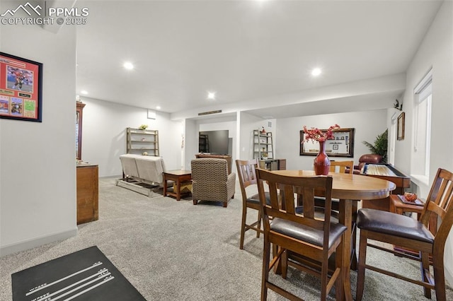 carpeted dining space with recessed lighting